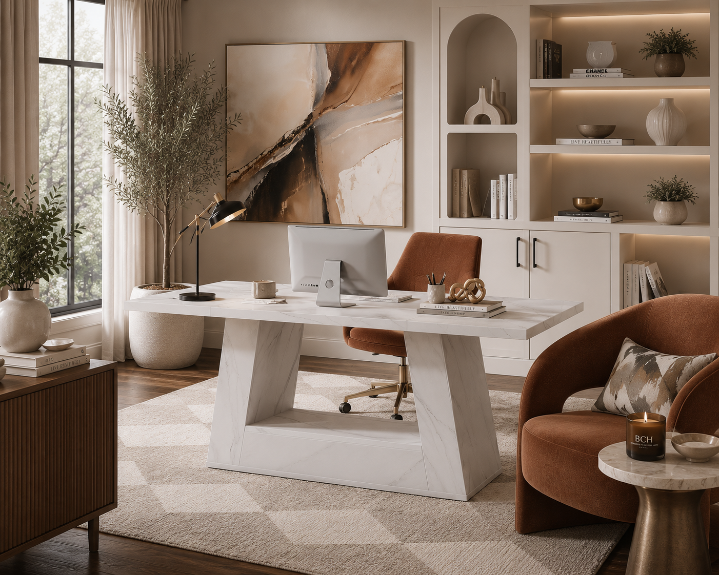 A modern white marble-top desk with a sculptural geometric base, styled in a warm, contemporary home office with a brown leather chair, shelving, and abstract wall art.