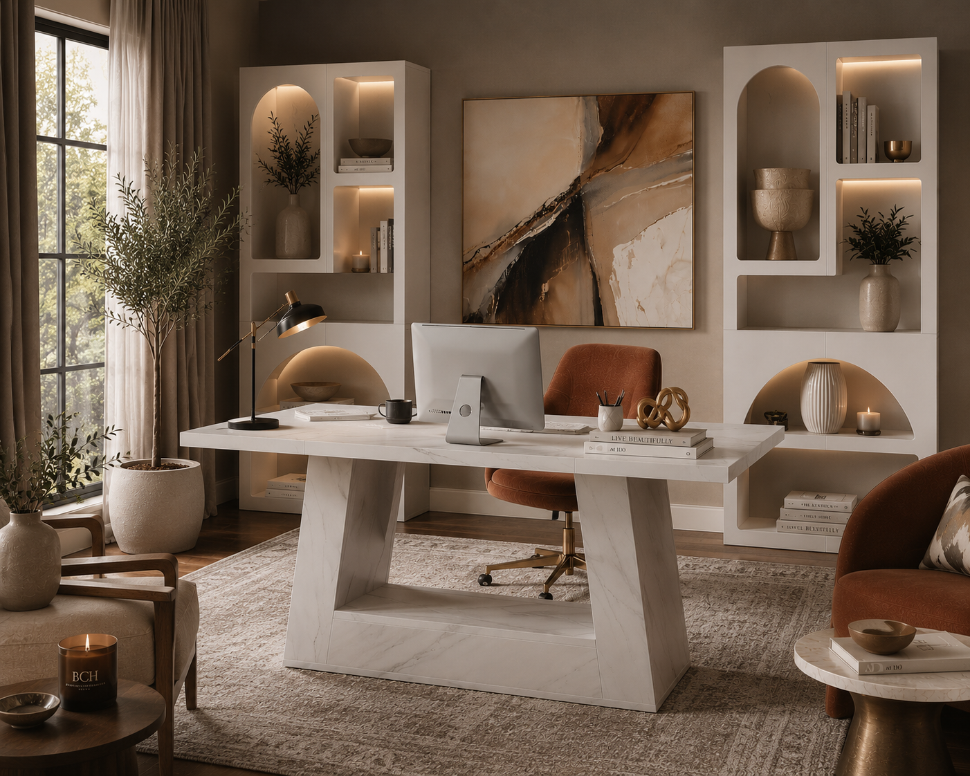 A modern white marble writing desk with a thick sculptural base, styled in a warm, contemporary home office with a brown leather swivel chair, shelving, and abstract wall art.