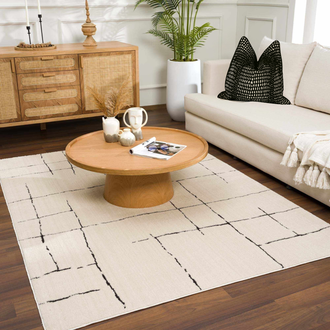Living room with a wooden coffee table, white sofa, and decorative items.