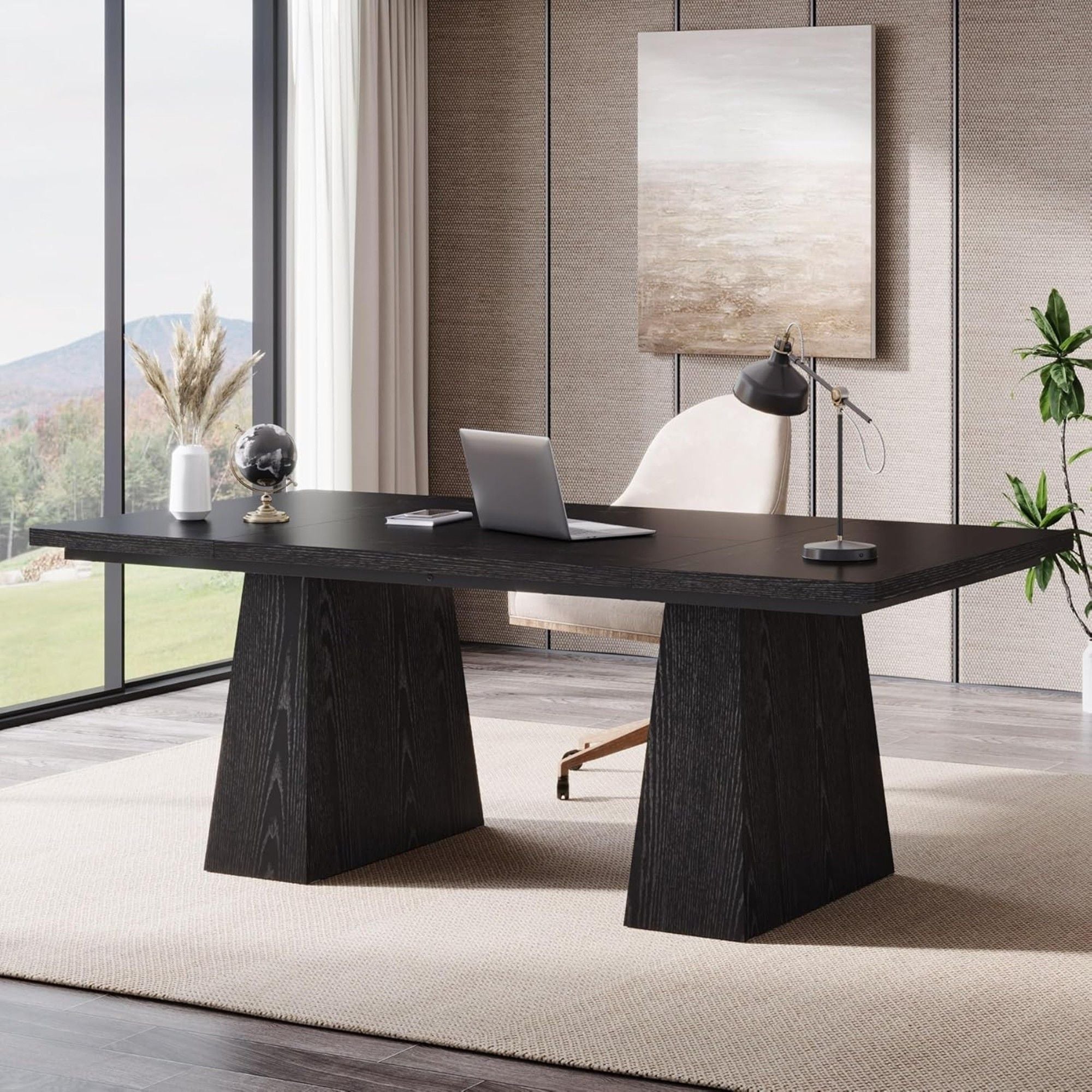 Modern office desk with laptop in a stylish room with large windows and decor.