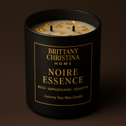 Black candle with gold text on a dark background