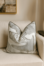Decorative pillow with abstract pattern on a beige sofa