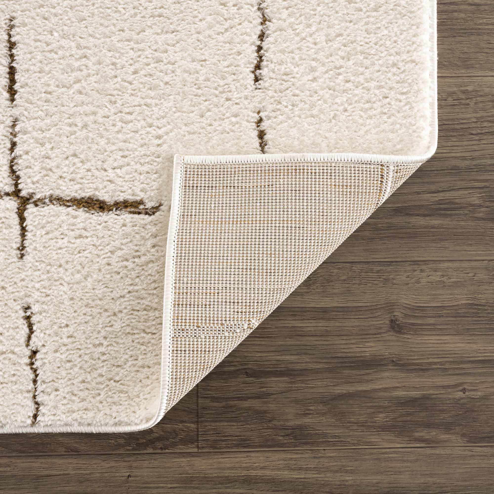 Beige textured rug on a wooden floor