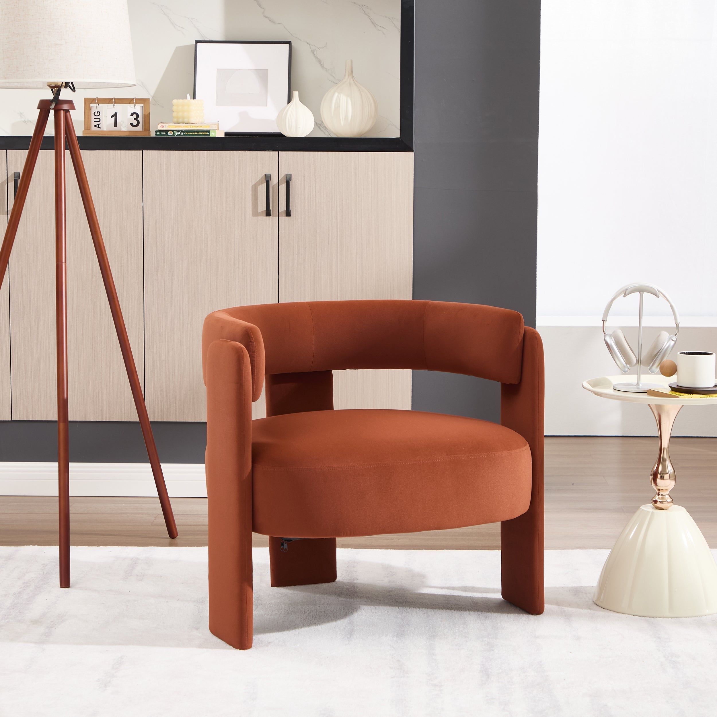 Modern rust-colored armchair in a stylish room with decor elements.