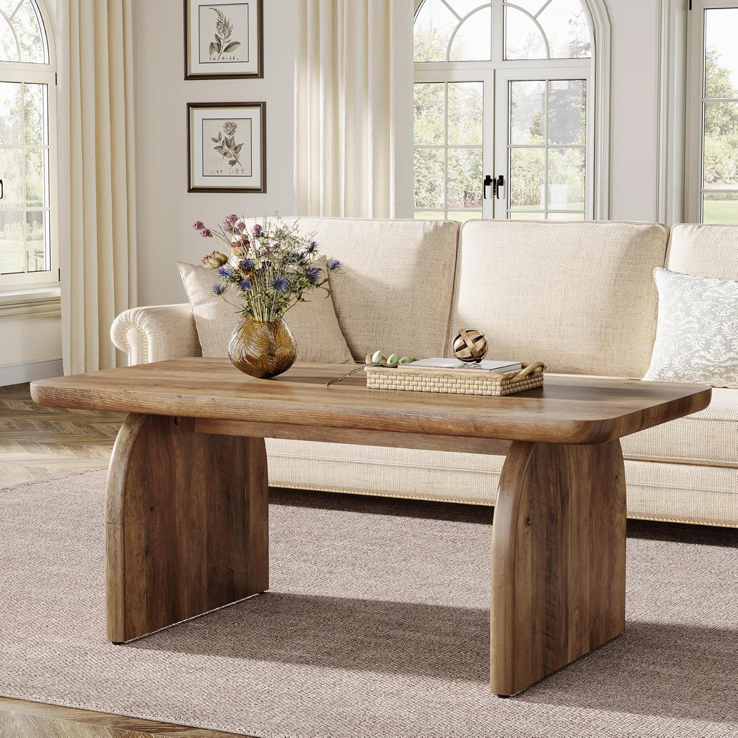 Wooden coffee table in a living room with a beige sofa and decorative items.